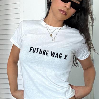 White fitted baby tee with black “Future WAG X” slogan, styled with a shoulder bag, perfect for football match days and trendy casual outfits