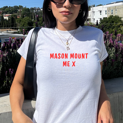 White fitted baby tee with red “Mason Mount Me X” slogan, styled casually with a shoulder bag, perfect for England football fans and match day outfits