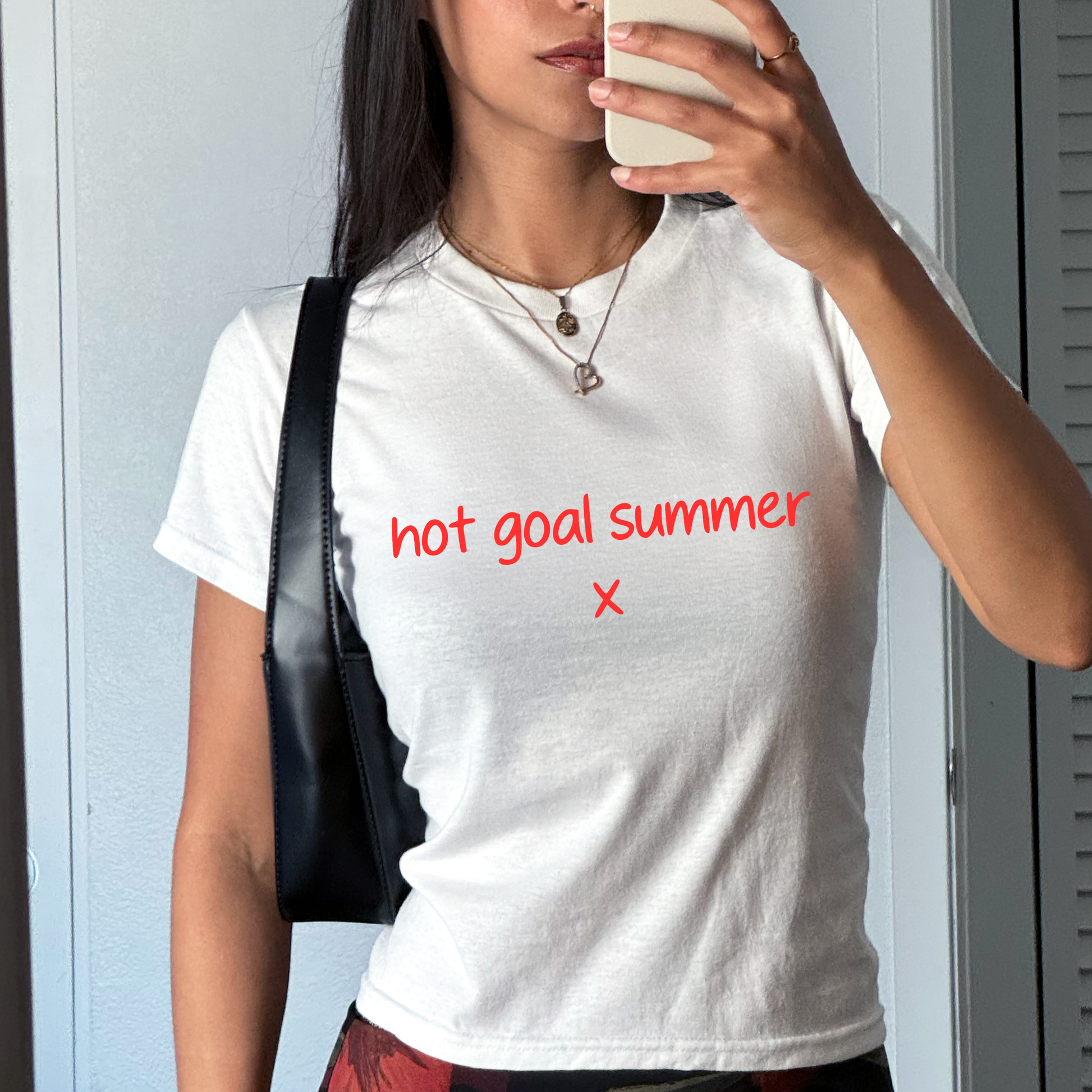 White baby tee with red “hot goal summer x” slogan, funny women’s football fan shirt